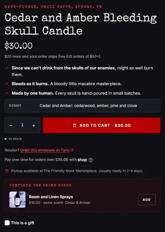 Product page: bleeding skull candle, buy box, new site, desktop view. Eyebrow, price, a free-shipping line tied to the checkout rule, three benefits, a Scent row with notes, one red 'Add to cart · $30.00' button, stock line, the Faire wholesale line.